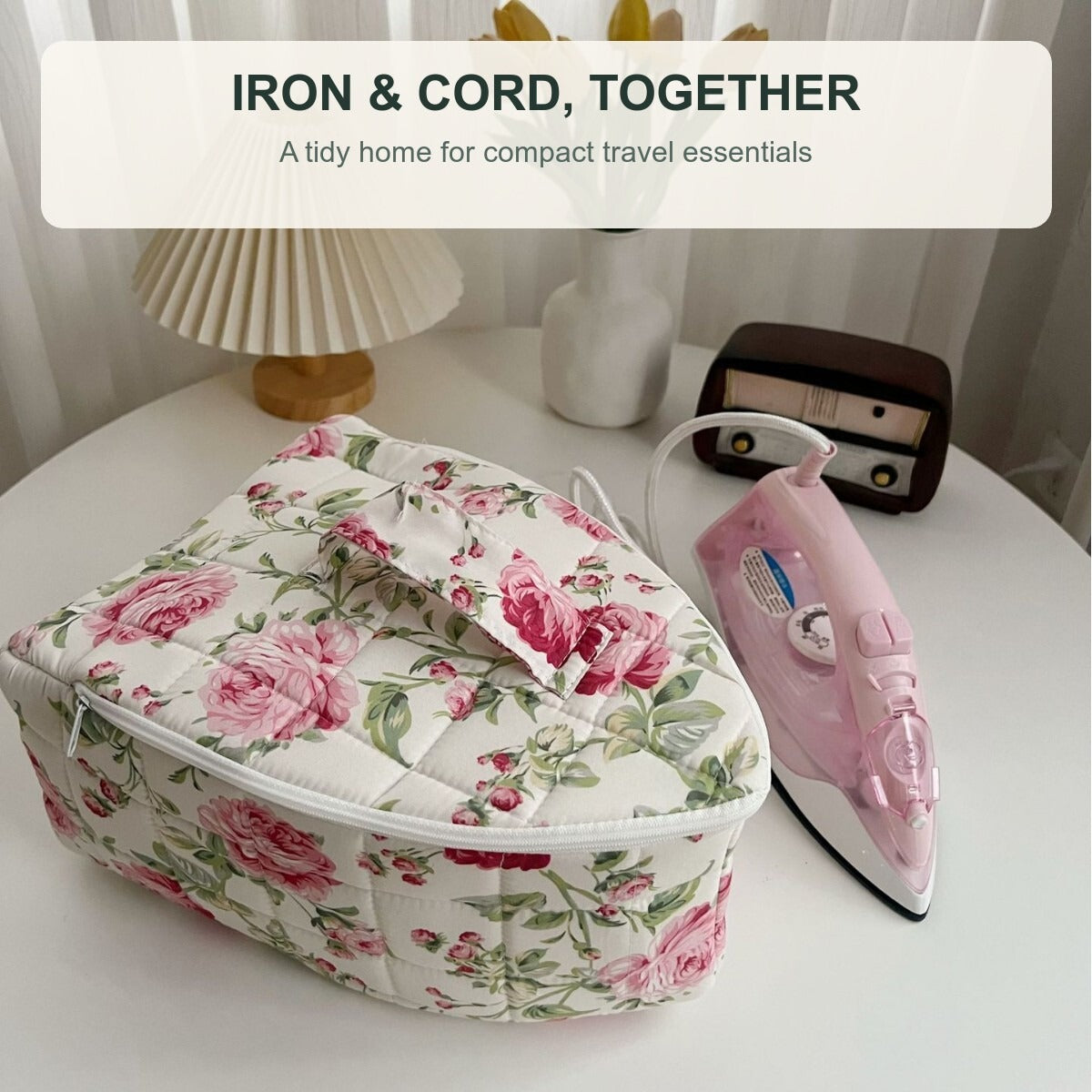 Travel iron and cord beside the rose-floral storage bag