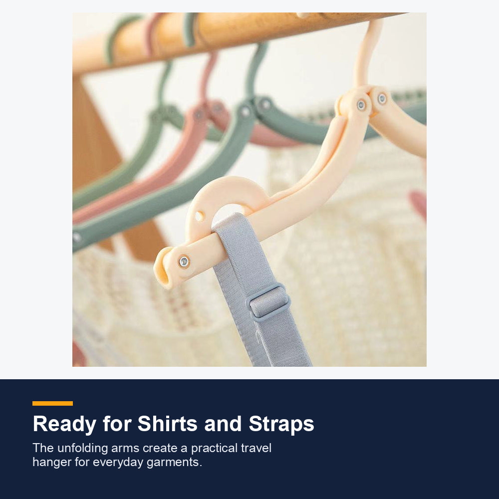 Folding travel hanger holding a garment strap